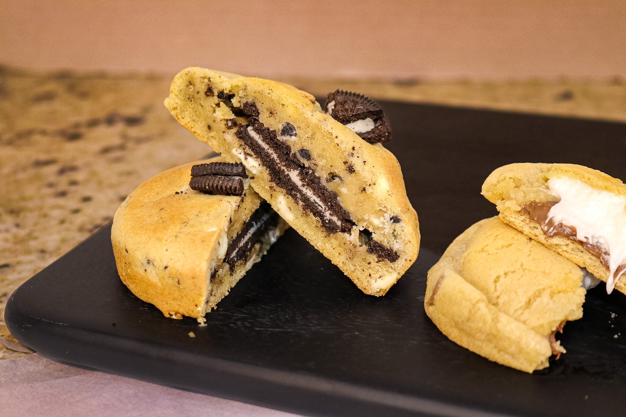 Cookies-and-cream stuffed cookie split open with a whole sandwich cookie baked inside
